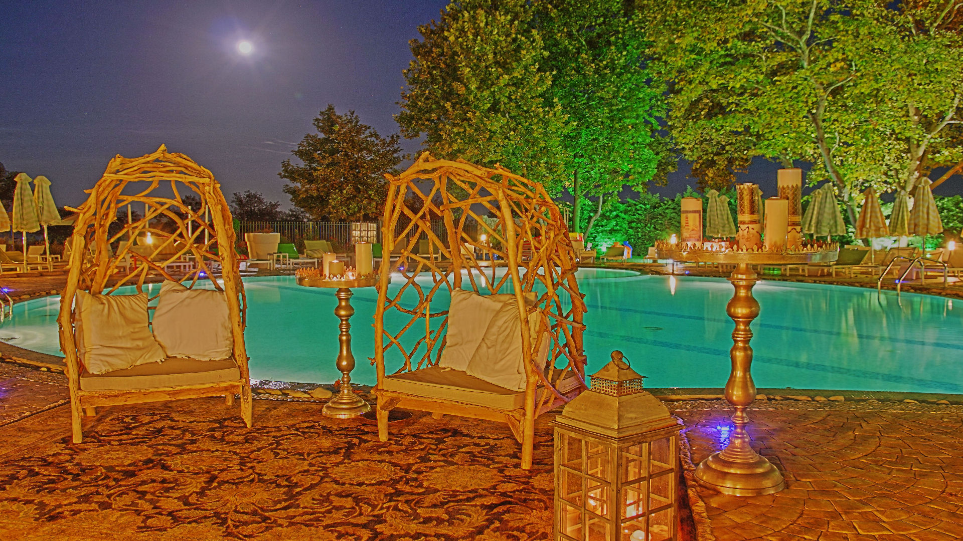 Pool at night with wicker lighting